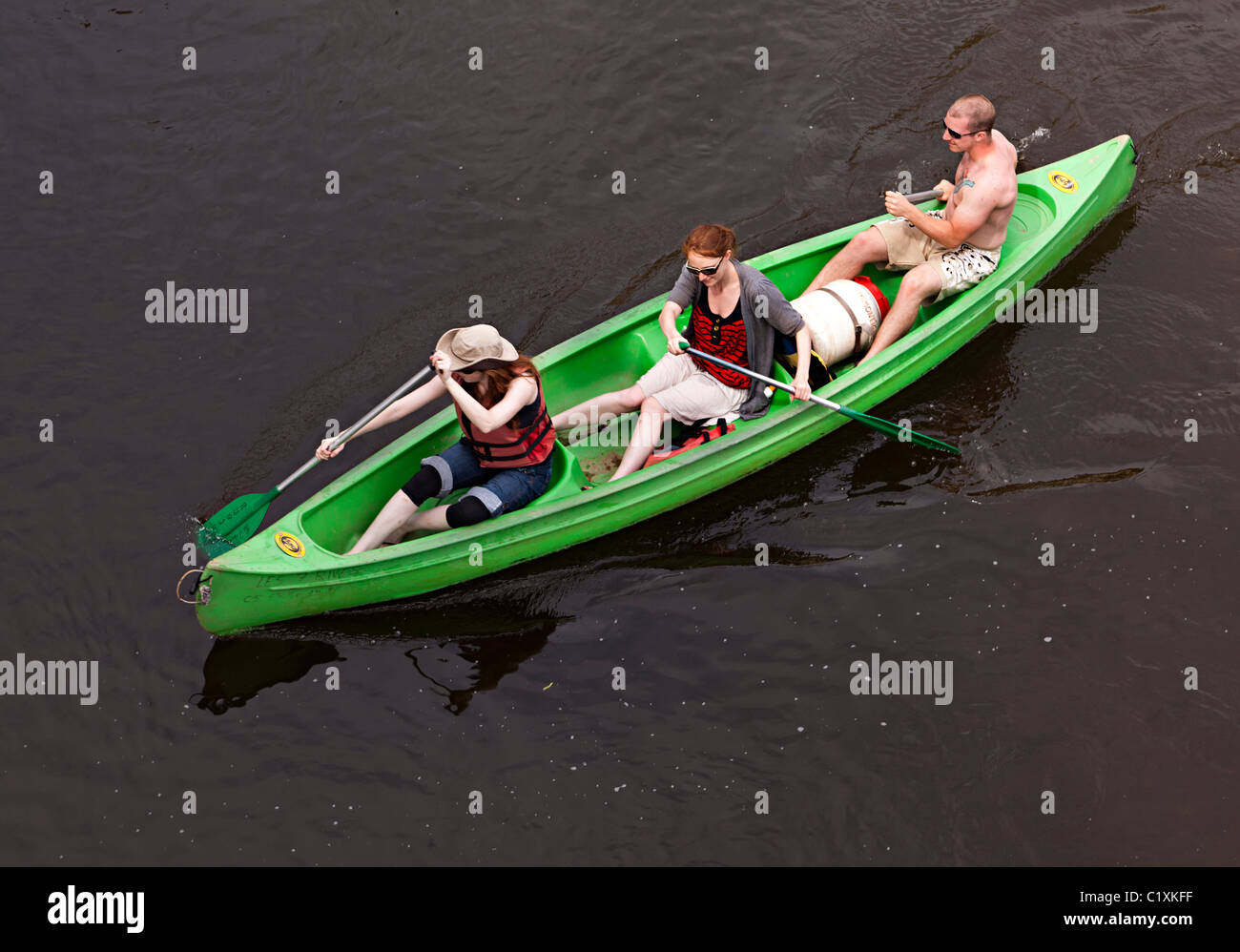 Three people in canoe on river Dordogne France Stock Photo
