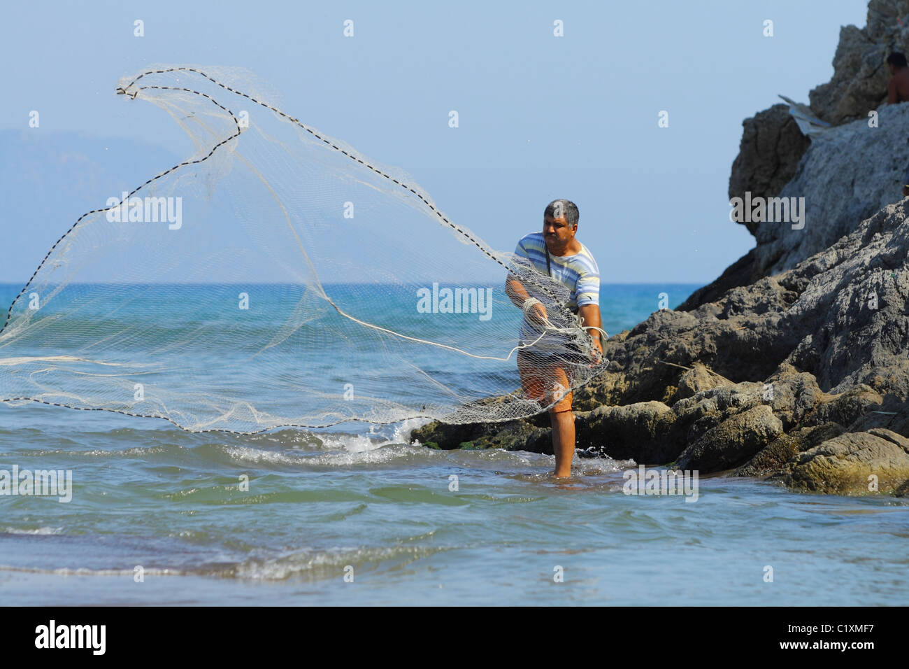 Man throwing a fishing net hi-res stock photography and images - Alamy