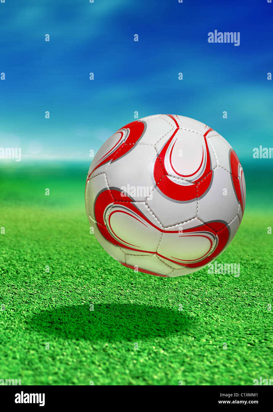 soccer ball on green ground in motion with path Stock Photo