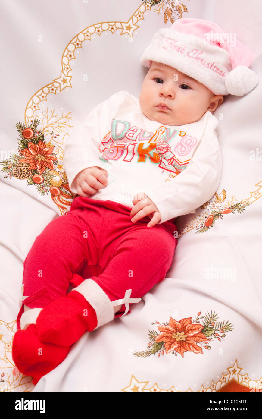 Baby in Christmas hat and outfit Stock Photo - Alamy