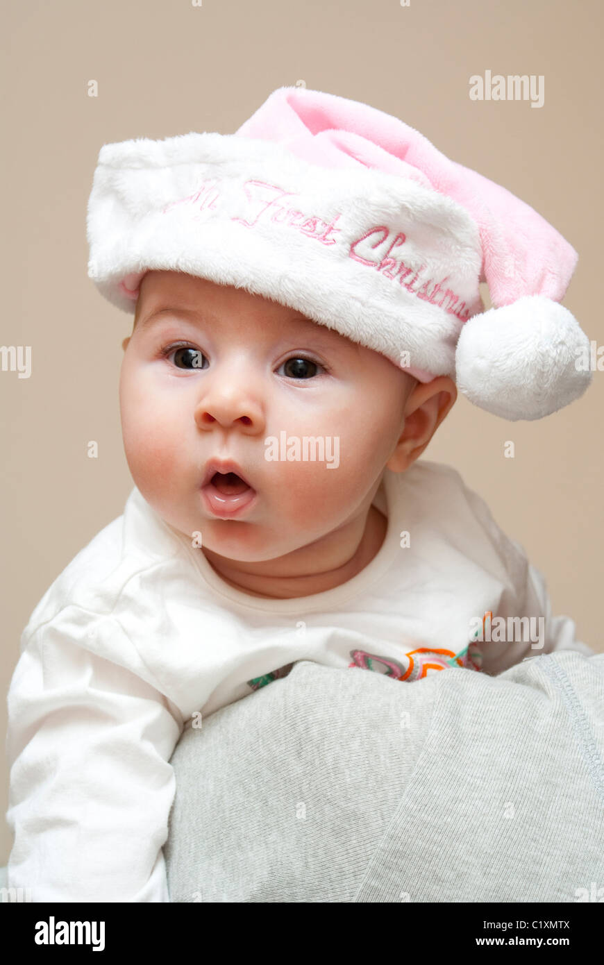 Baby in Christmas hat and outfit Stock Photo - Alamy