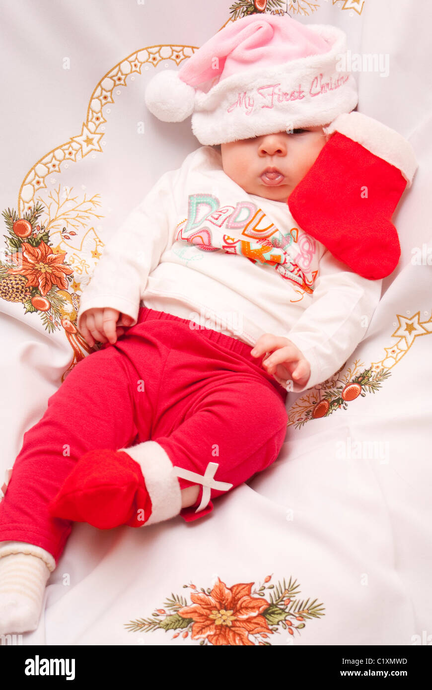 Baby in Christmas hat and outfit Stock Photo - Alamy