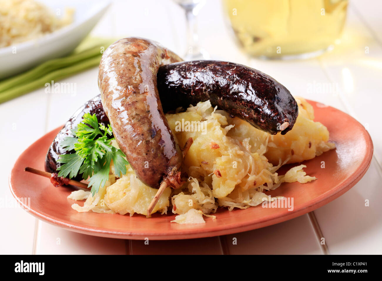 Blood sausage and white pudding with sauerkraut and potatoes Stock