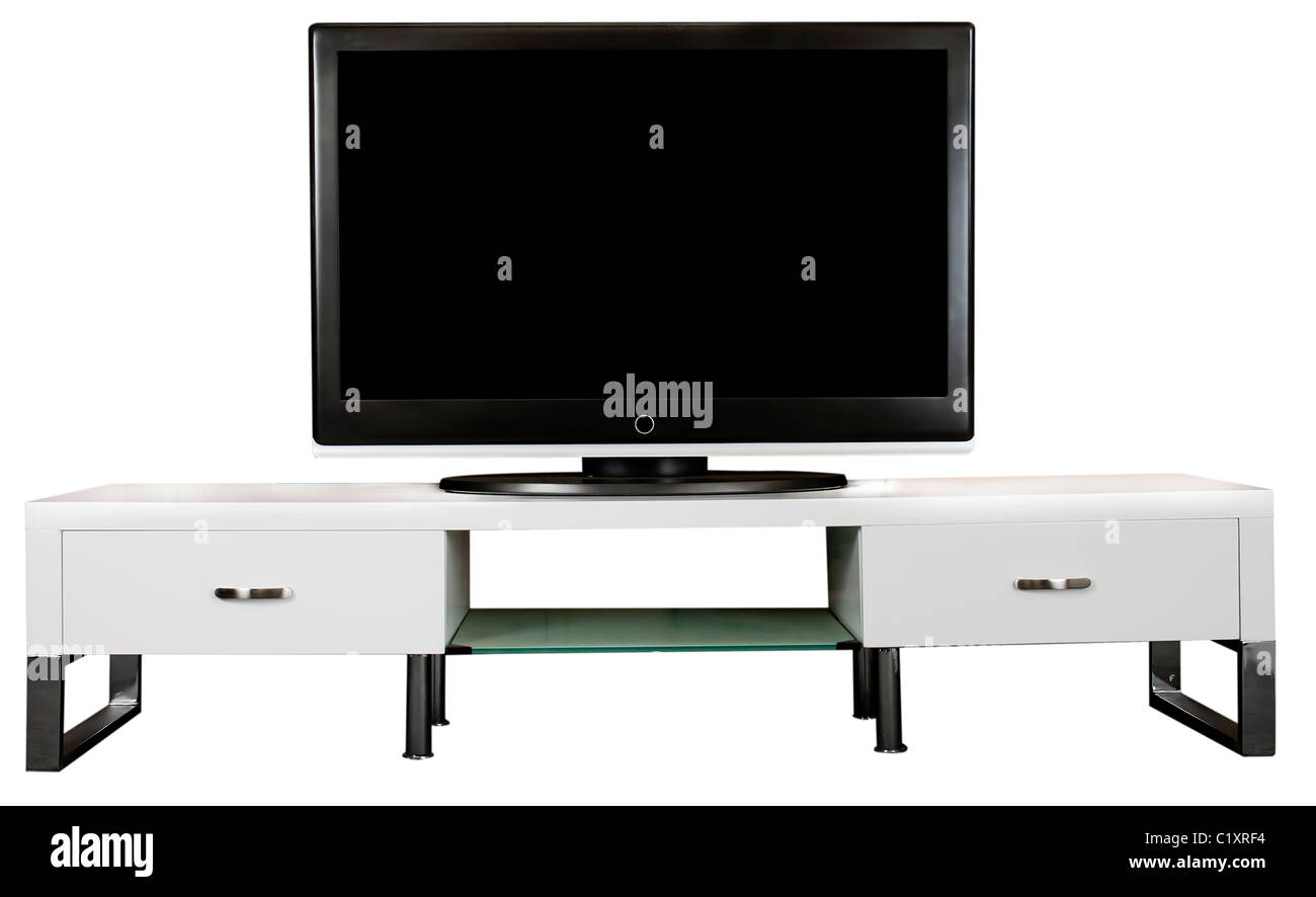 A modern white TV Cabinet with a large LCD TV on it. Stock Photo