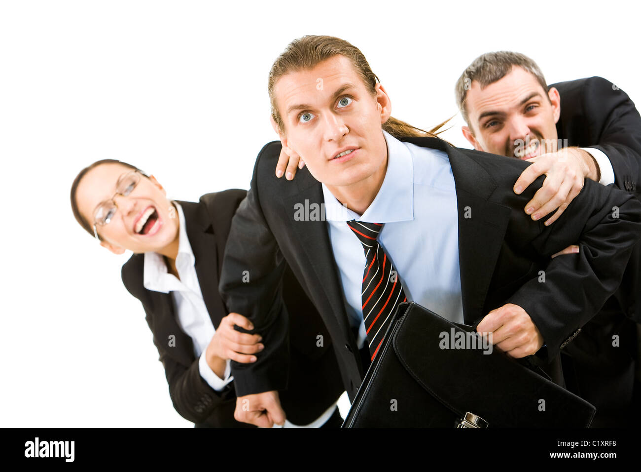 Image of businessman trying to free from his co-workers’ hands Stock Photo