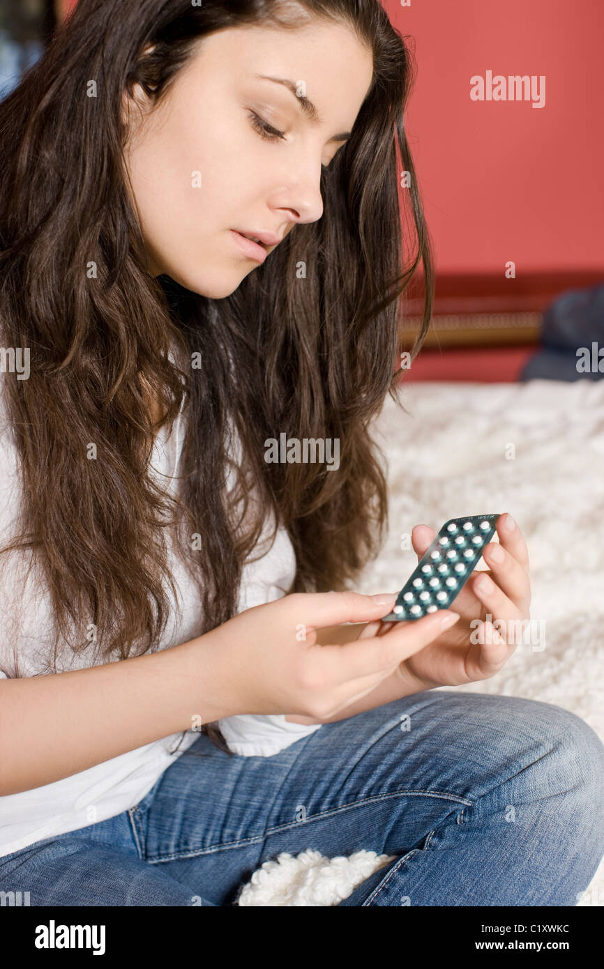 Young woman holding birth control pills Stock Photo