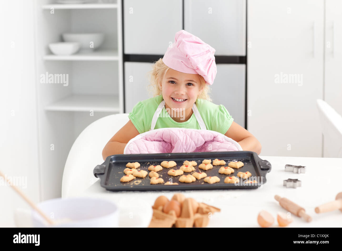 Happy little girl holding a plate with cookies ready to eat Stock Photo ...