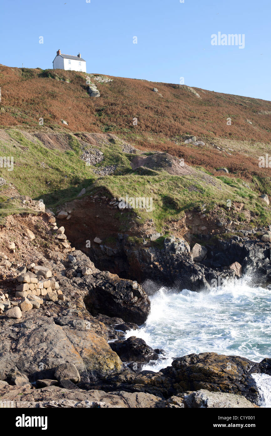 White house on top of cliff looking over Cape Cornwall Stock Photo