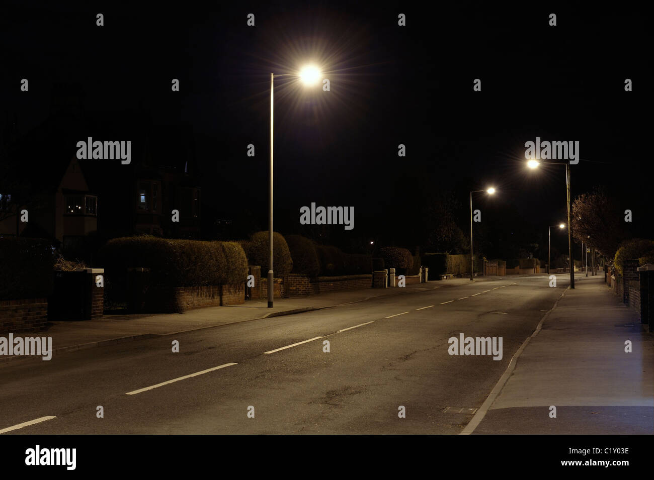 Deserted suburban street at night Stock Photo