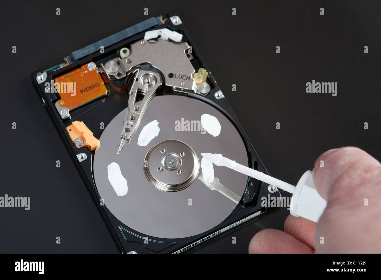 Tippex on a hard drive platter 'erase data / mistakes!' Stock Photo