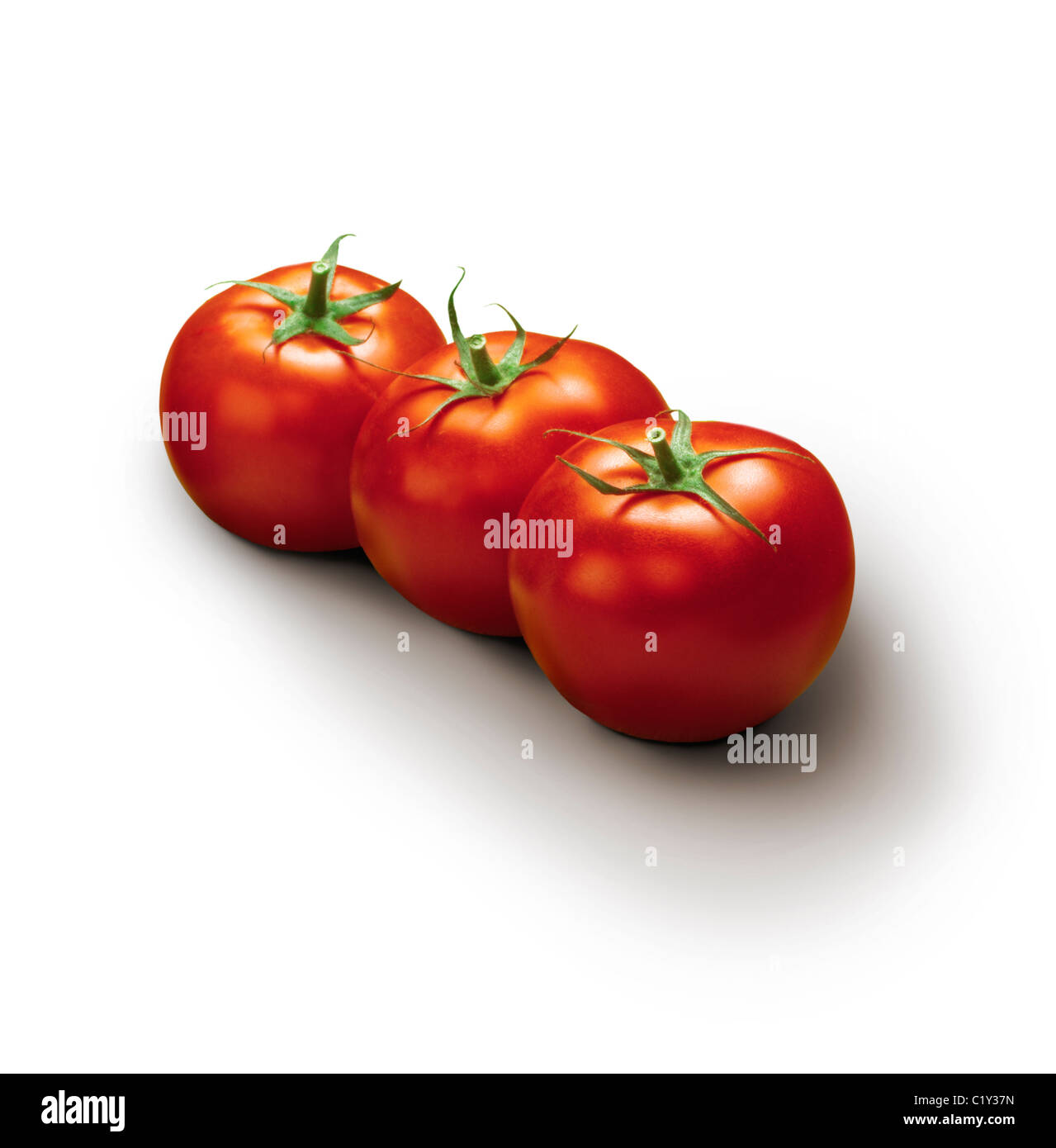 three tomatoes on a white background Stock Photo - Alamy