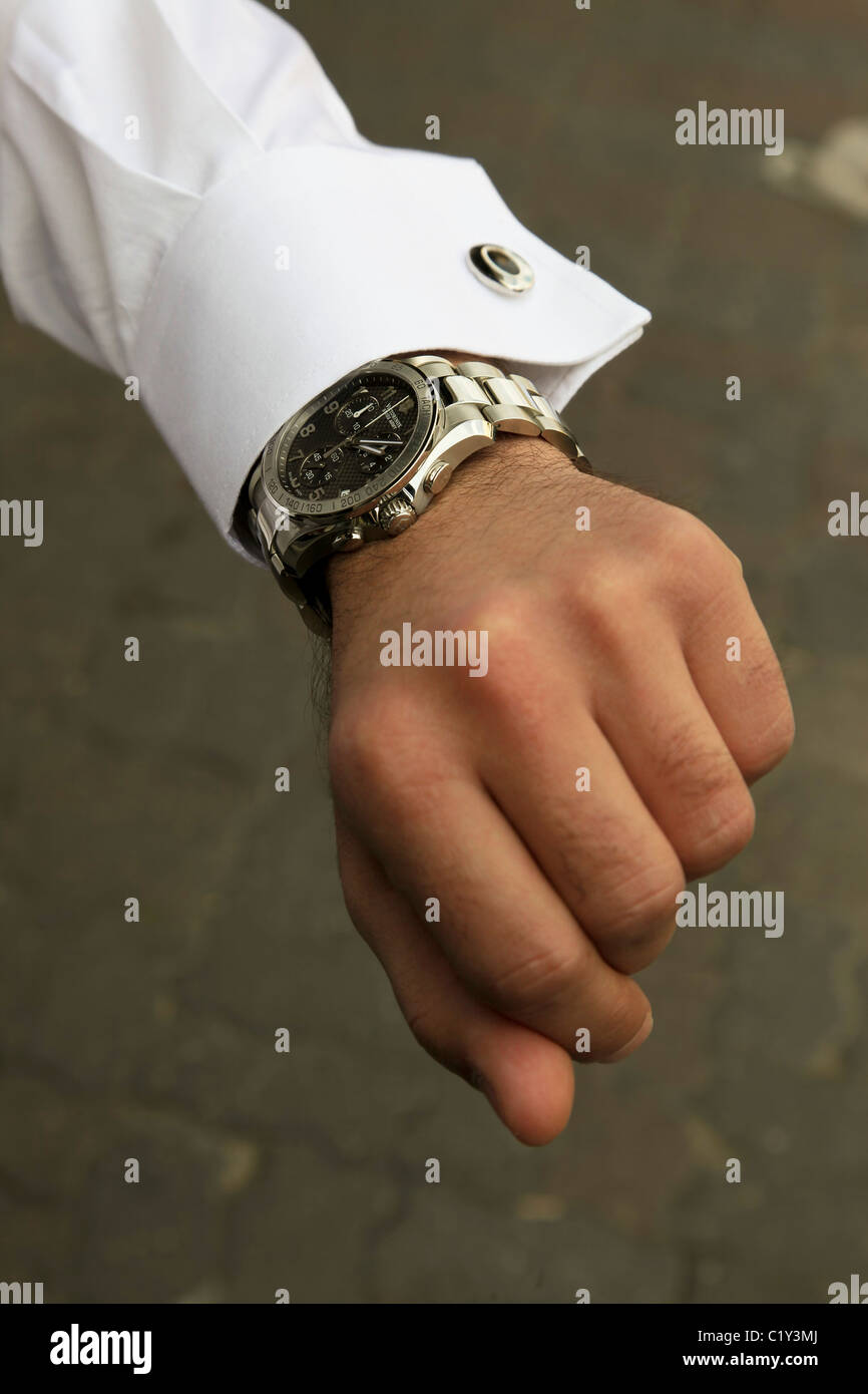 Man looks at his wrist watch Stock Photo