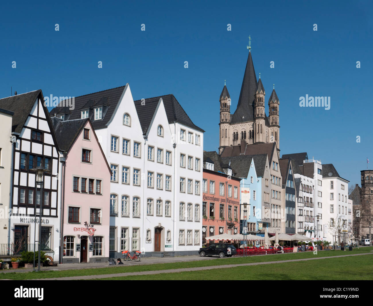 Historic style buildings and Gross St Martins Church in Altstadt or Old Town of Cologne beside the river Rhine Germany Stock Photo