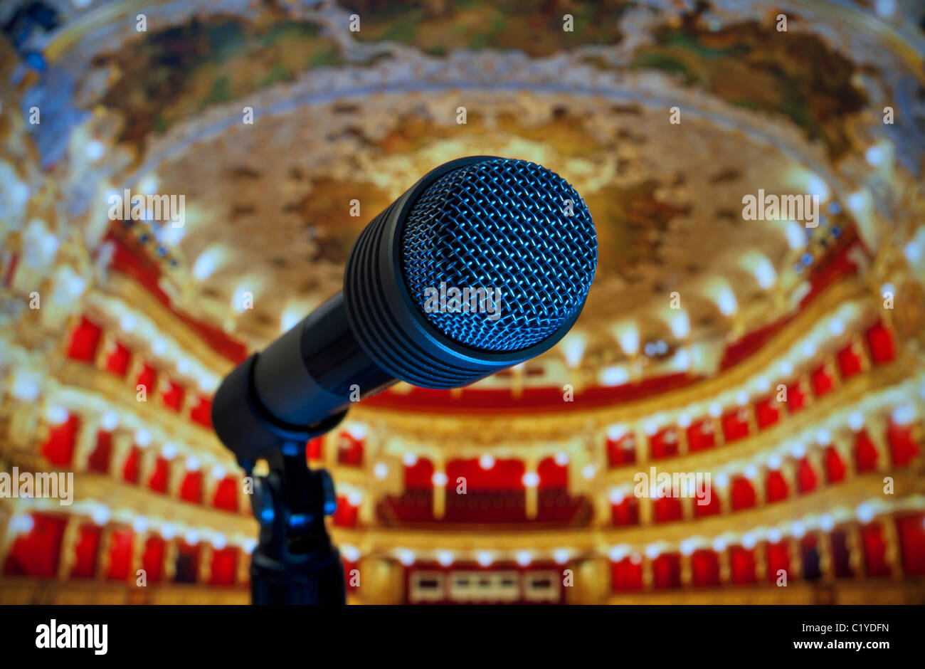 Microphone close-up in Theatre Auditorium Performance Stage is set, interior in background concepts Performance Stage Fright Rehearsal Recording Sound Stock Photo