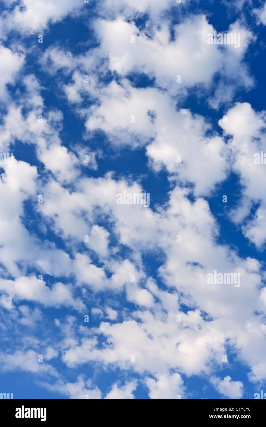 White puffy clouds rising into the sky. Stock Photo