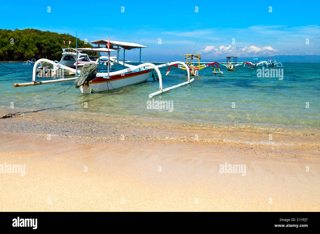 Beach with anchored traditional boats in Gili island Stock Photo