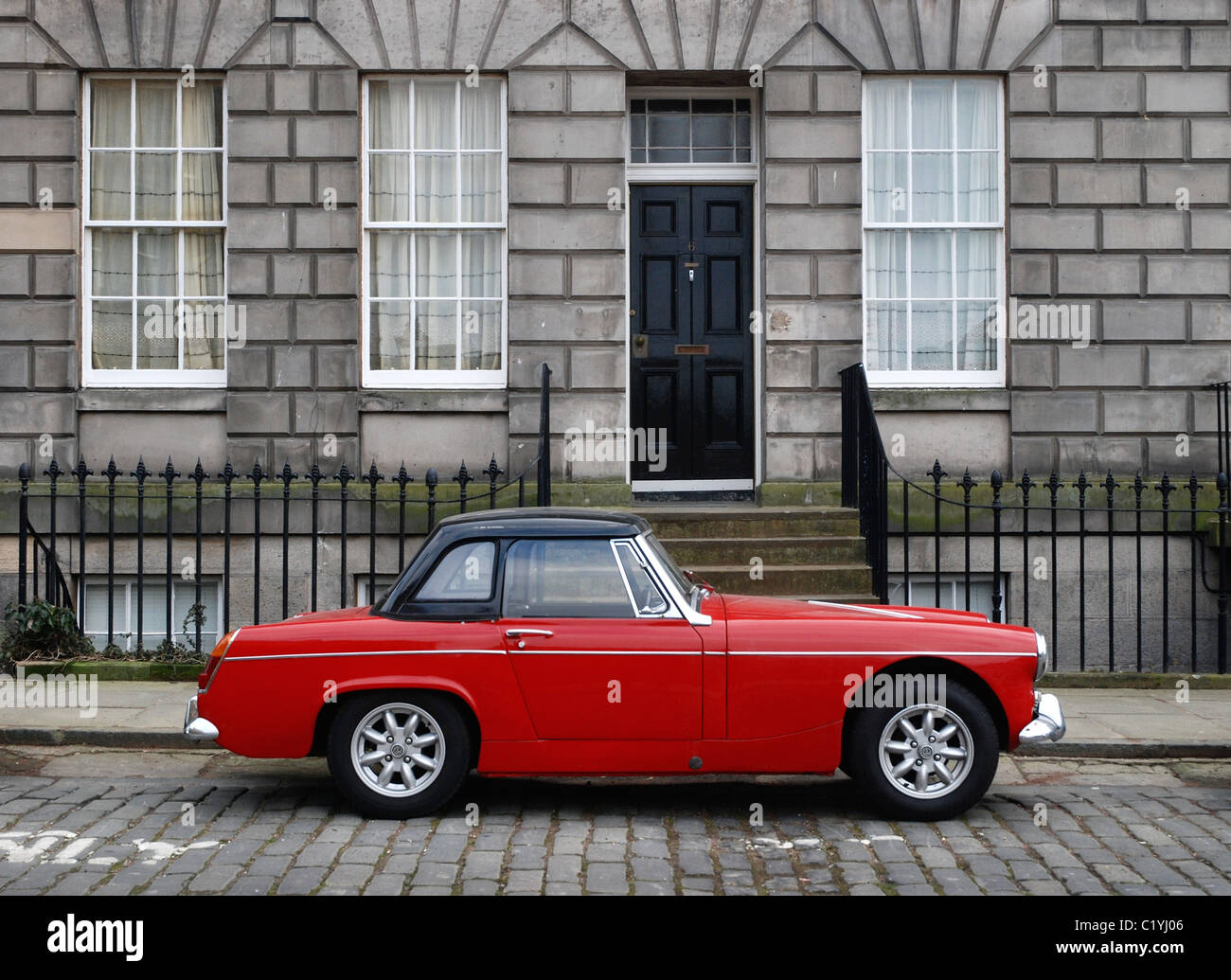 A red MG midget parked on a cobbled street in Keir Street, Edinburgh, Scotland, UK. Stock Photo