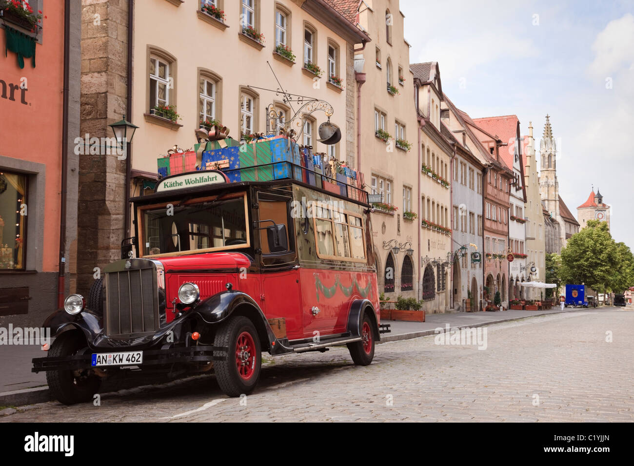 Red vintage Asquith car in cobbled street advertising famous Kathe Wohlfahrt Christmas store. Rothenburg Ob der Tauber, Bavaria, Germany, Europe Stock Photo