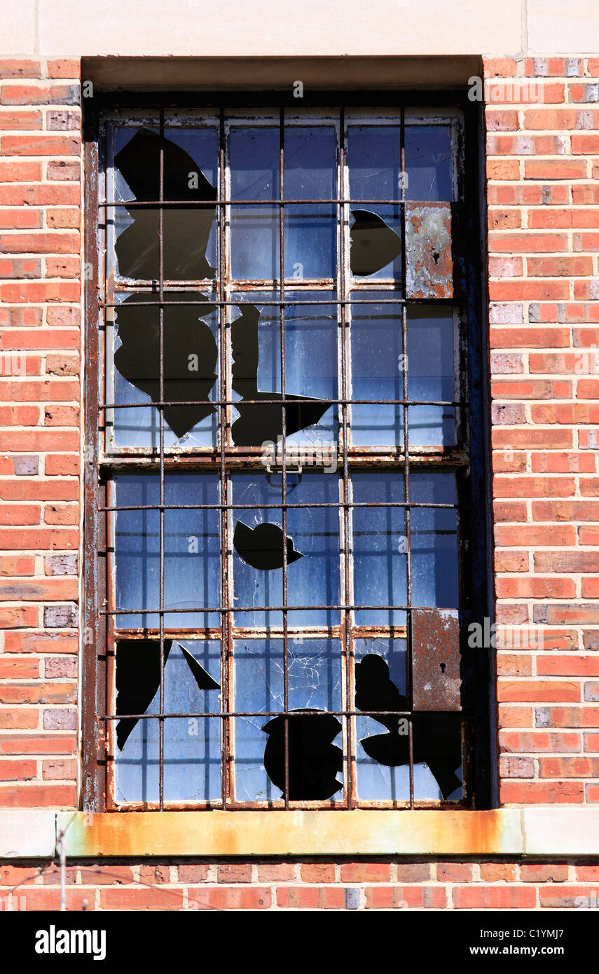 Broken window, grounds of closed Kings Park psychiatric hospital, Long Island NY Stock Photo