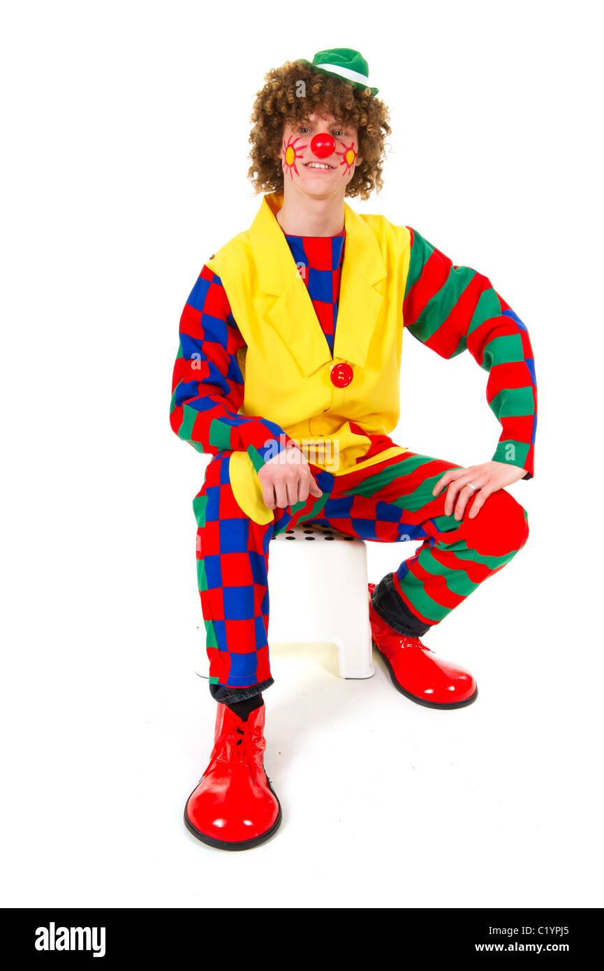 Funny clown sitting with big shoes and red nose Stock Photo