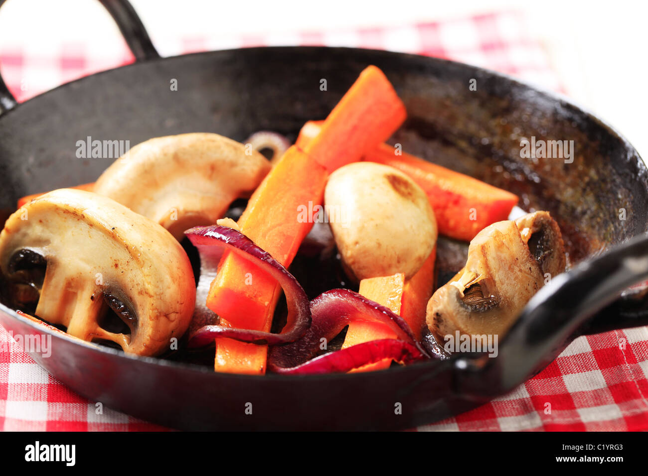 Pan roasted mushrooms, and strips of carrot Stock Photo