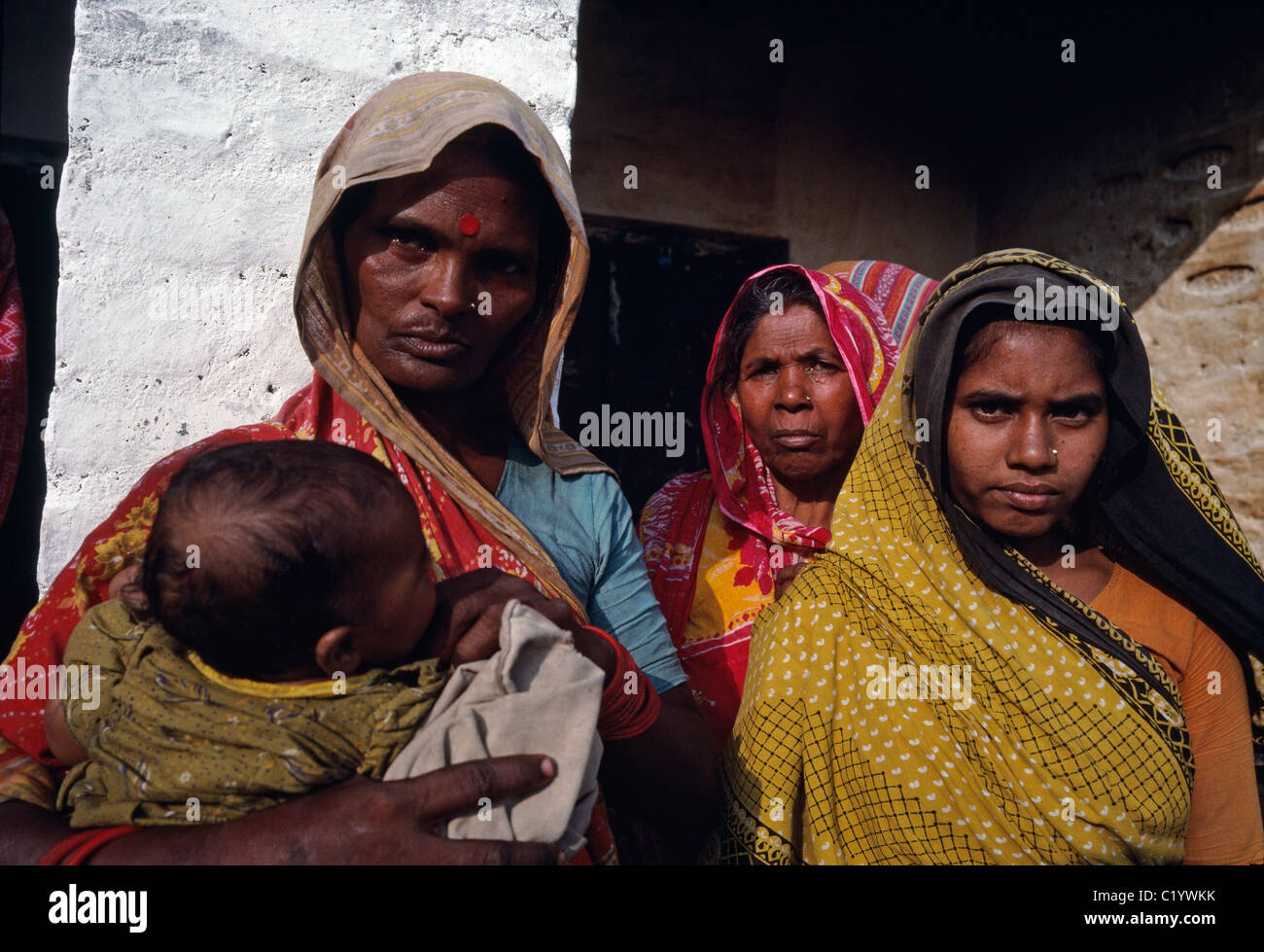 A group of lower caste Indian women stand in front of a building in rural Bihar, India. Stock Photo