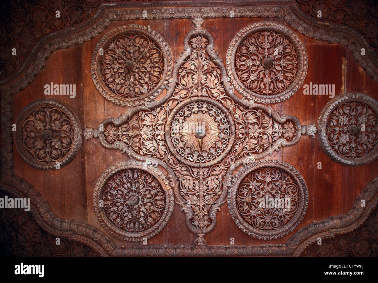 An strawIntricate molding and woodworking is part of a ceiling in a palace built for the Maharaja of Bikaner,  Rajasthan, India. Stock Photo