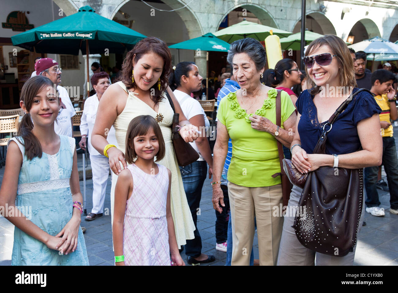 middle class family portrait two pretty young Mexican sisters with mother aunt & grandmother in Oaxaca Zocalo Mexico Stock Photo