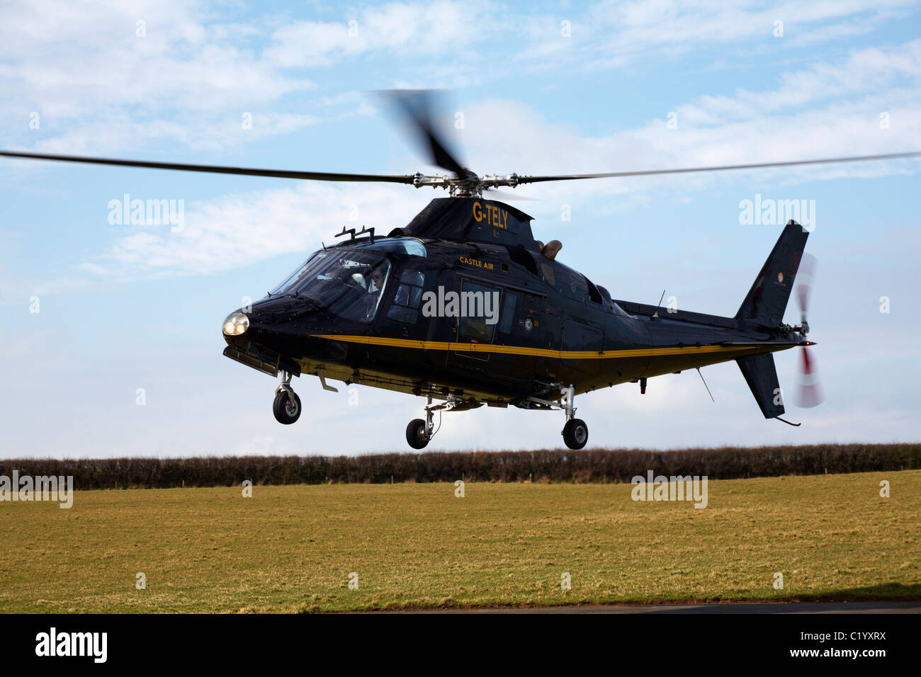 Helicopter coming in to land at Hartland Point, Devon taking visitors to and from Lundy in March Stock Photo