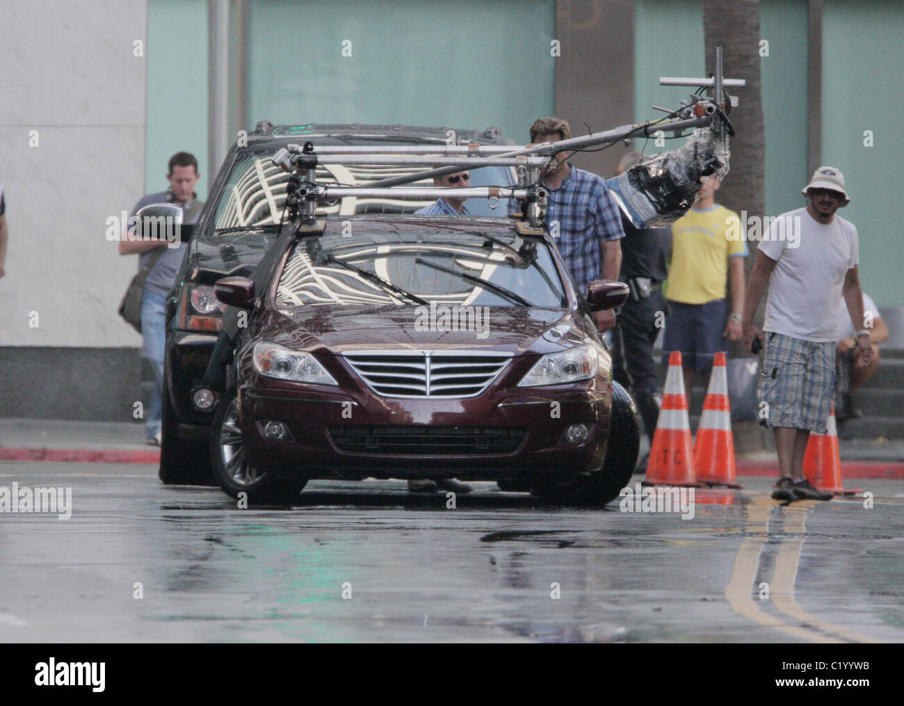 Leonardo DiCaprio driving a car in the rain while filming a scene for