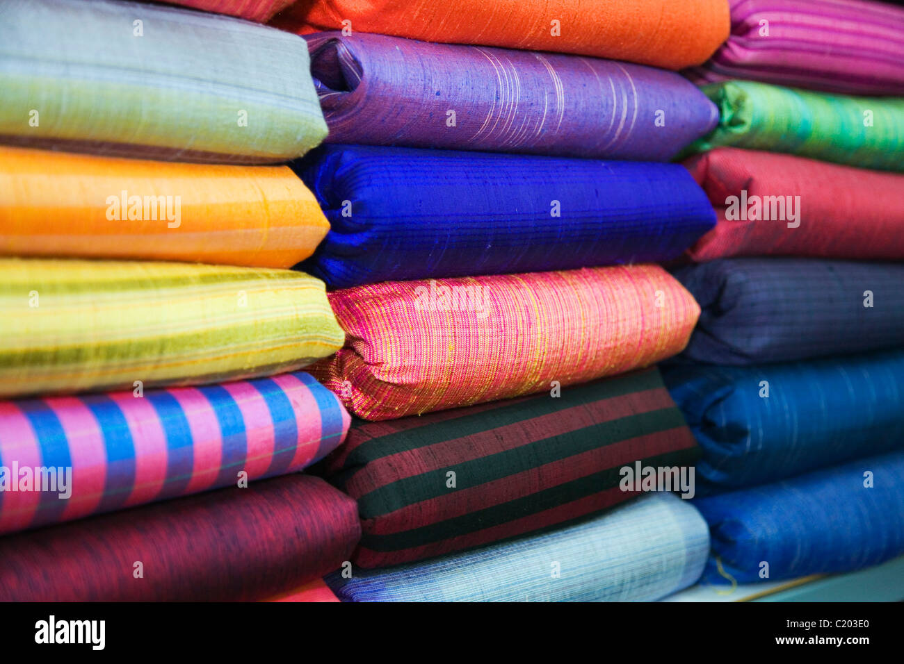 Piles of fine silk fabric at Pak Thong Chai, near Phimai, Nakhon Ratchasima province, THAILAND. Stock Photo