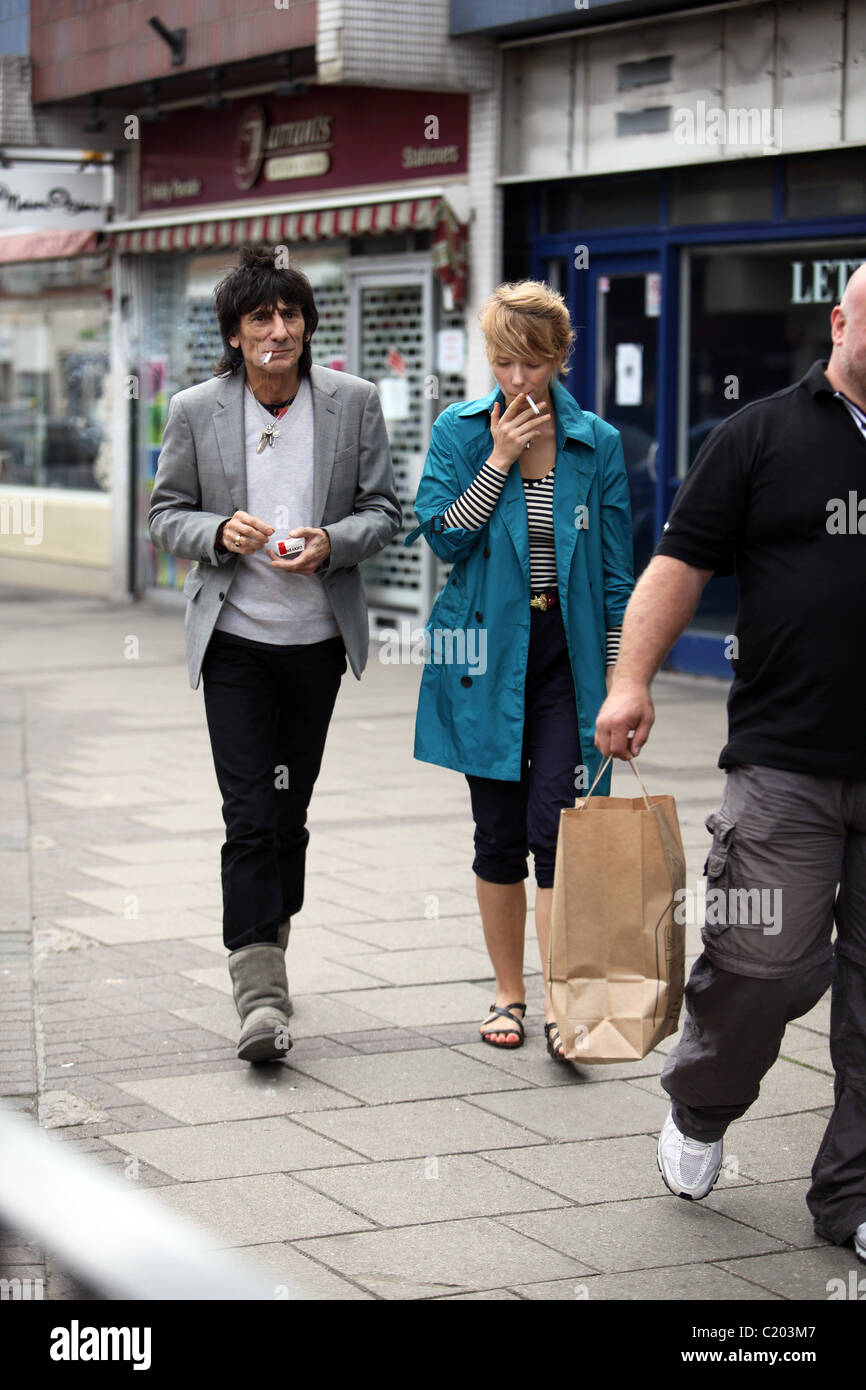 Ronnie Wood and Ekaterina Ivanova each smoke a cigarette as they go shopping for Ronnie's newly purchased flat only hours after Stock Photo