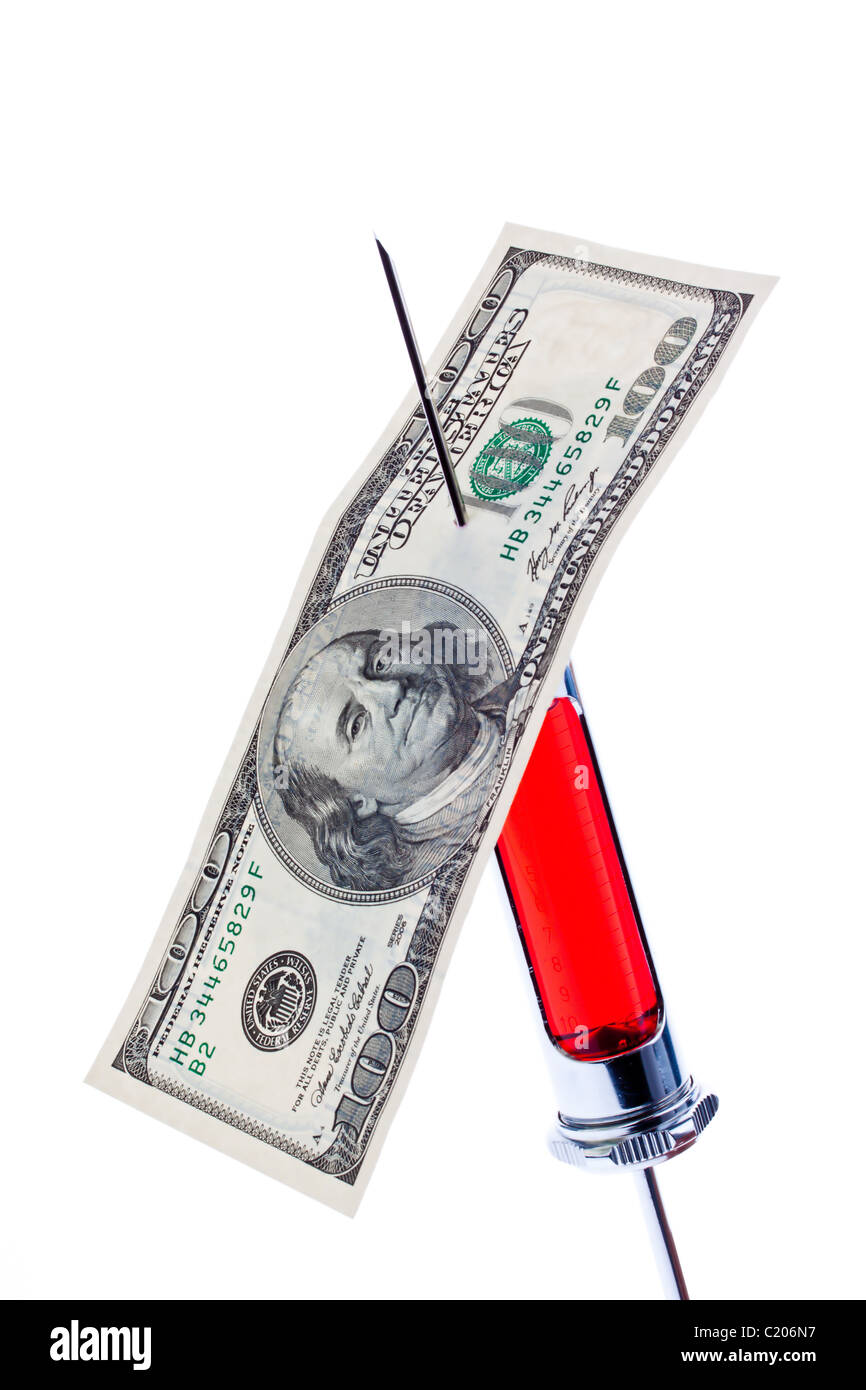 Injection needle and syringe with a dollar bill Stock Photo