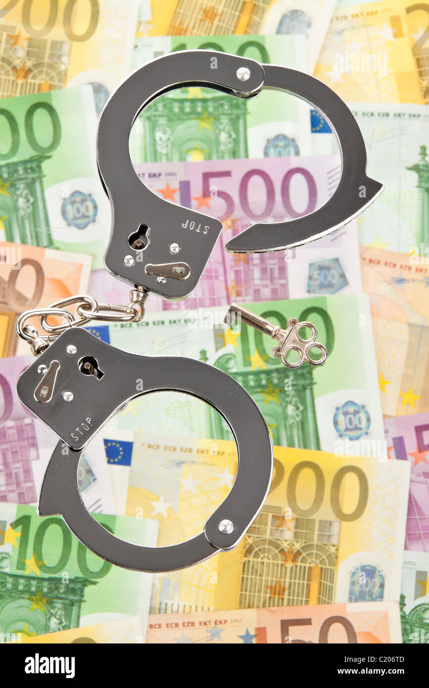 Euro bank notes with handcuffs Stock Photo
