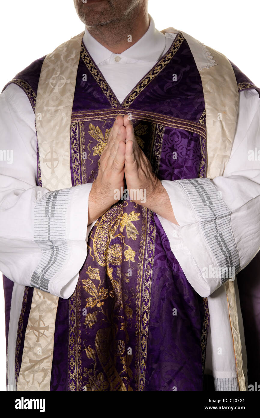 Catholic priests in prayer in worship Stock Photo