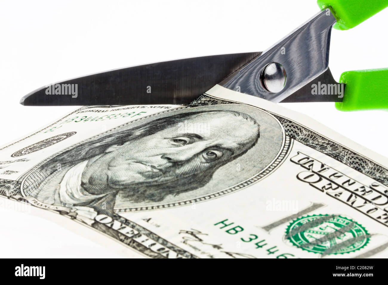 Dollar money bills and scissors Stock Photo
