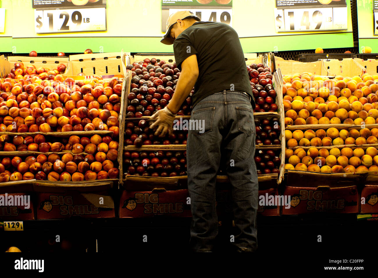 Grocery man stacking fruit outside grocery store in New York City USA Stock Photo Alamy
