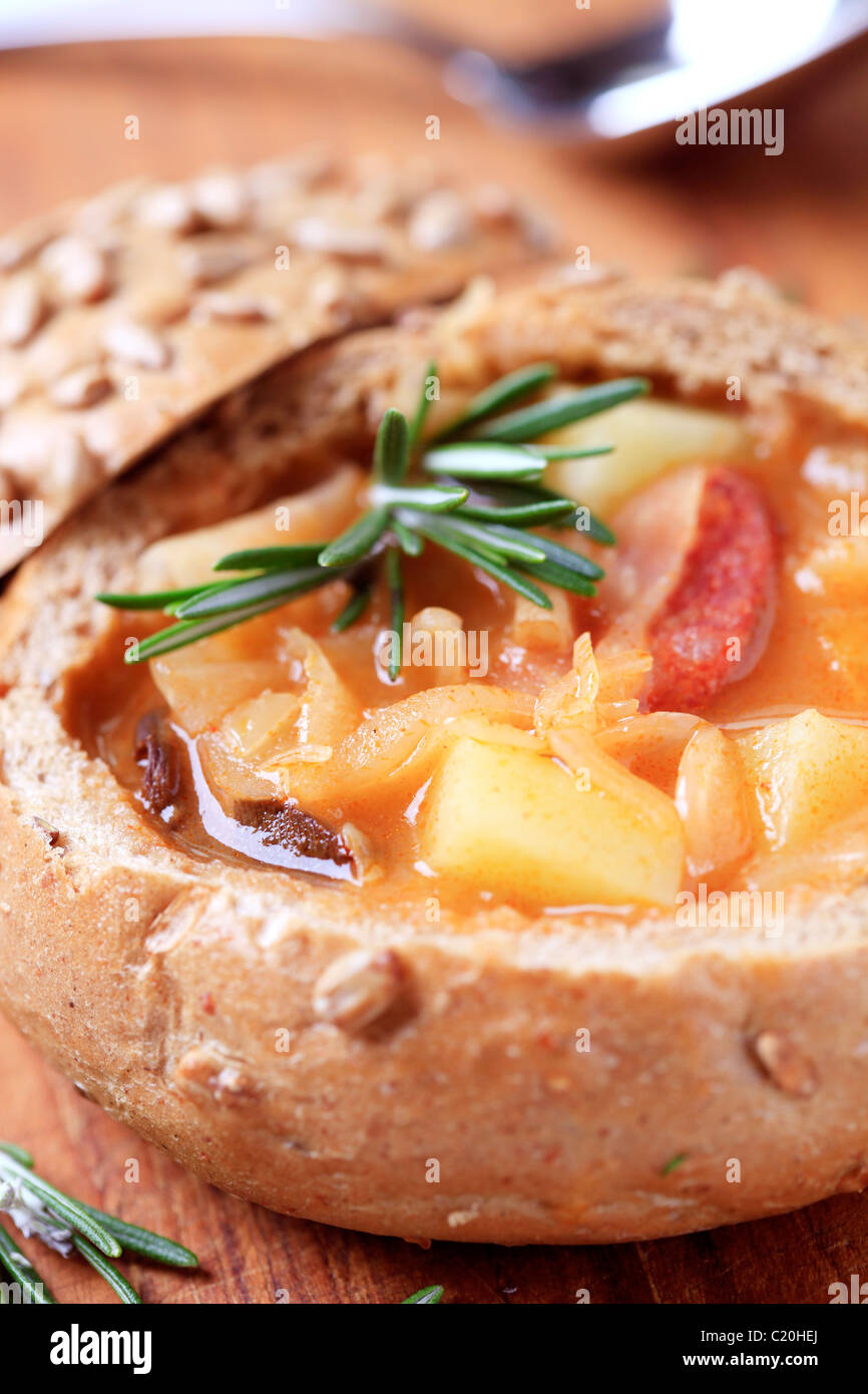 Sauerkraut soup with potatoes and sausage served in a bread bowl Stock