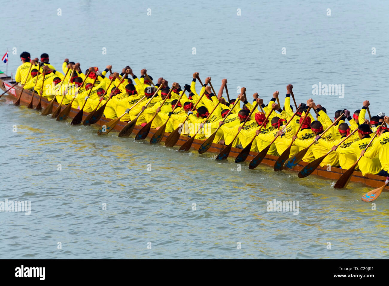 Long-boat team on the Chakrai River during the Phimai Festival boat races. Phimai, Nakhon Ratchasima province, THAILAND Stock Photo