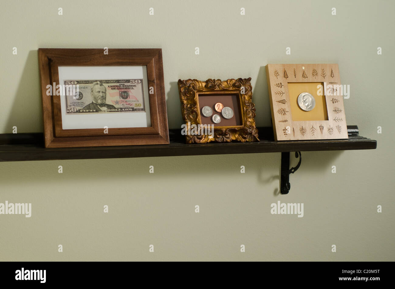 US currency in picture frames on shelf Stock Photo Alamy