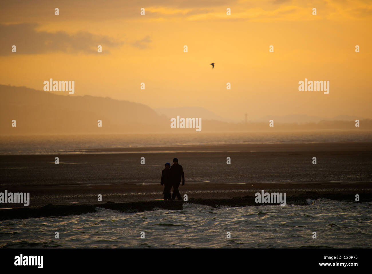 Couple walking at West Kirby, Wirral, England, February, 2011 Stock Photo