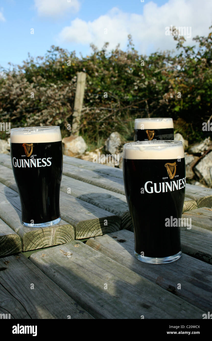 Three pints enjoying fresh air out side a pub in Donegal Stock Photo