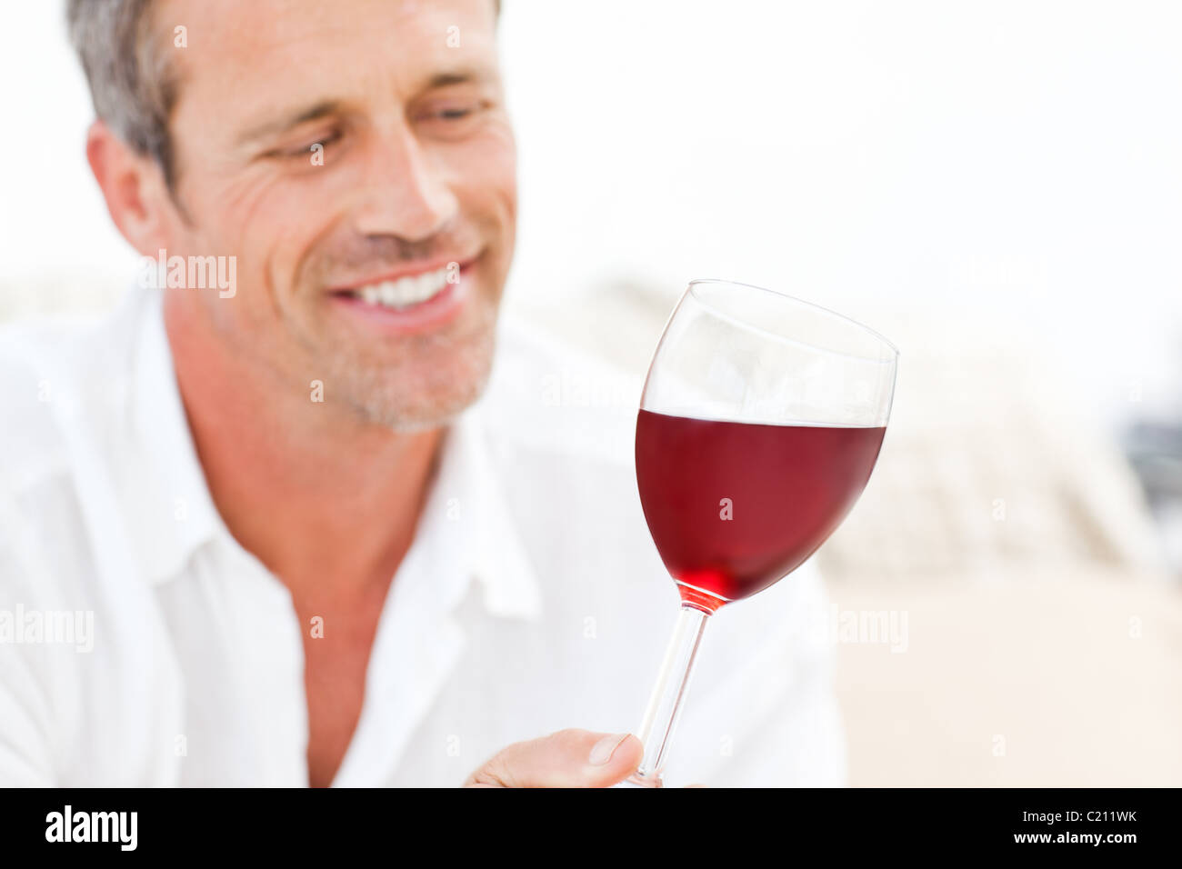 Handsome man drinking some red wine Stock Photo - Alamy