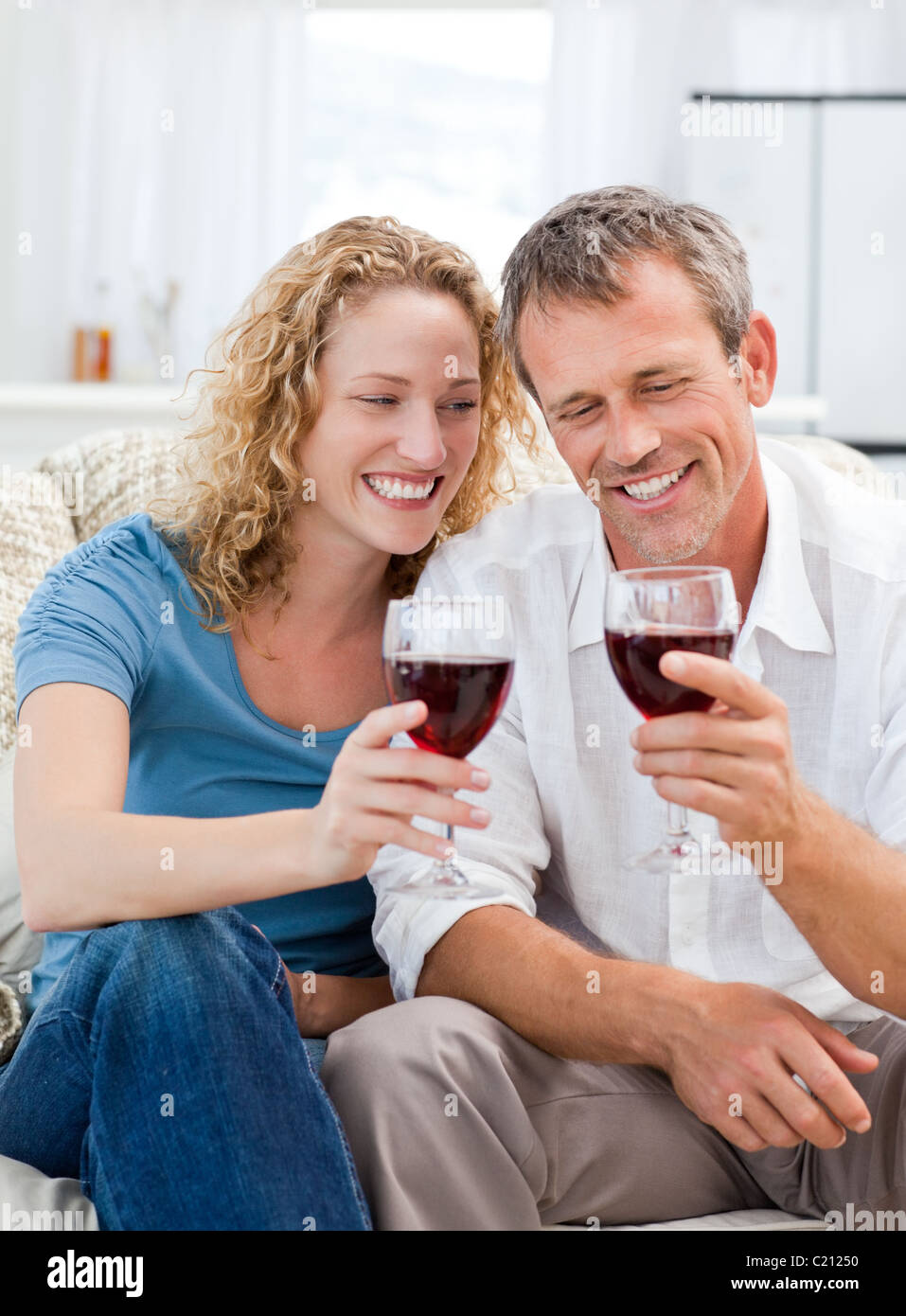 Couple drinking some red wine in the living room Stock Photo Alamy