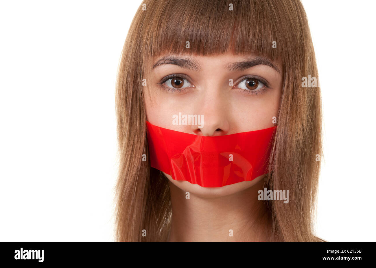 beautiful girl with her mouth sealed with red tape Stock Photo