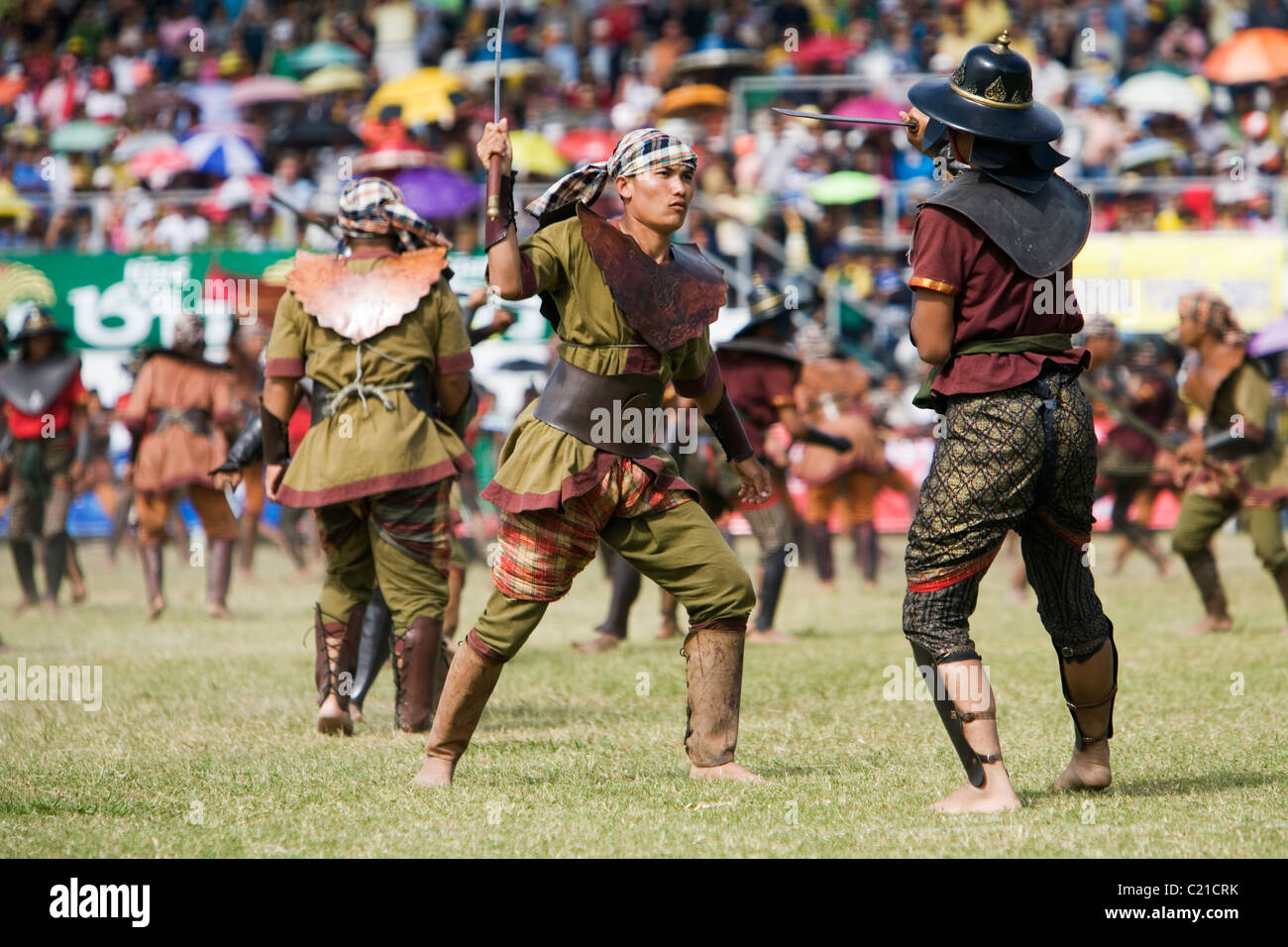 Soldiers battle in an ancient war re-enactment during the annual Surin Elephant Roundup festival.  Surin, Surin, Thailand Stock Photo