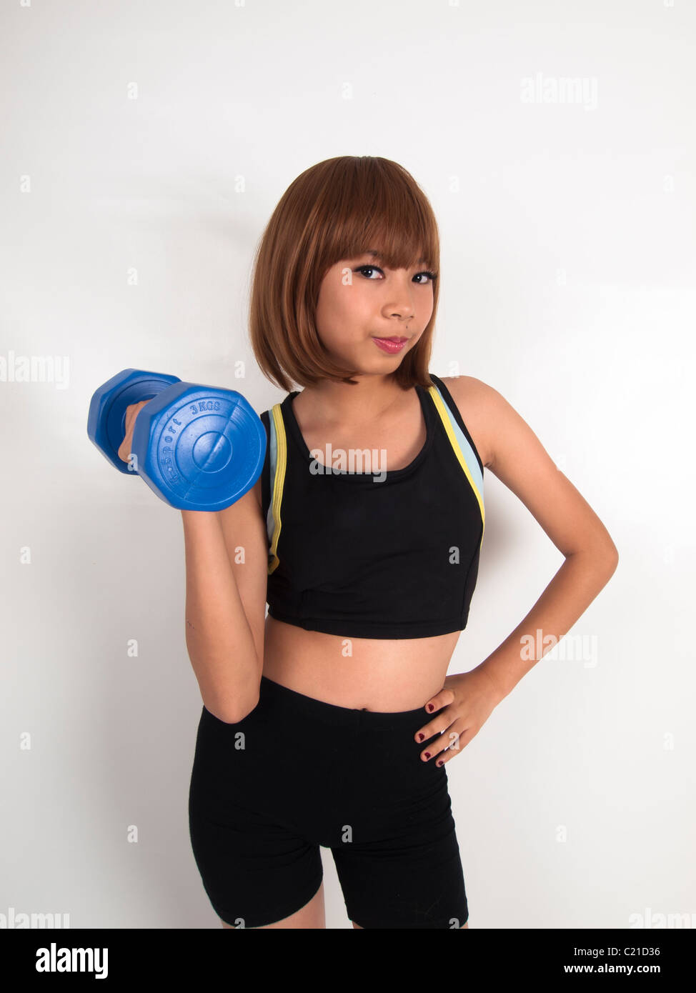 A cute Asian woman workout on weight lifting Stock Photo