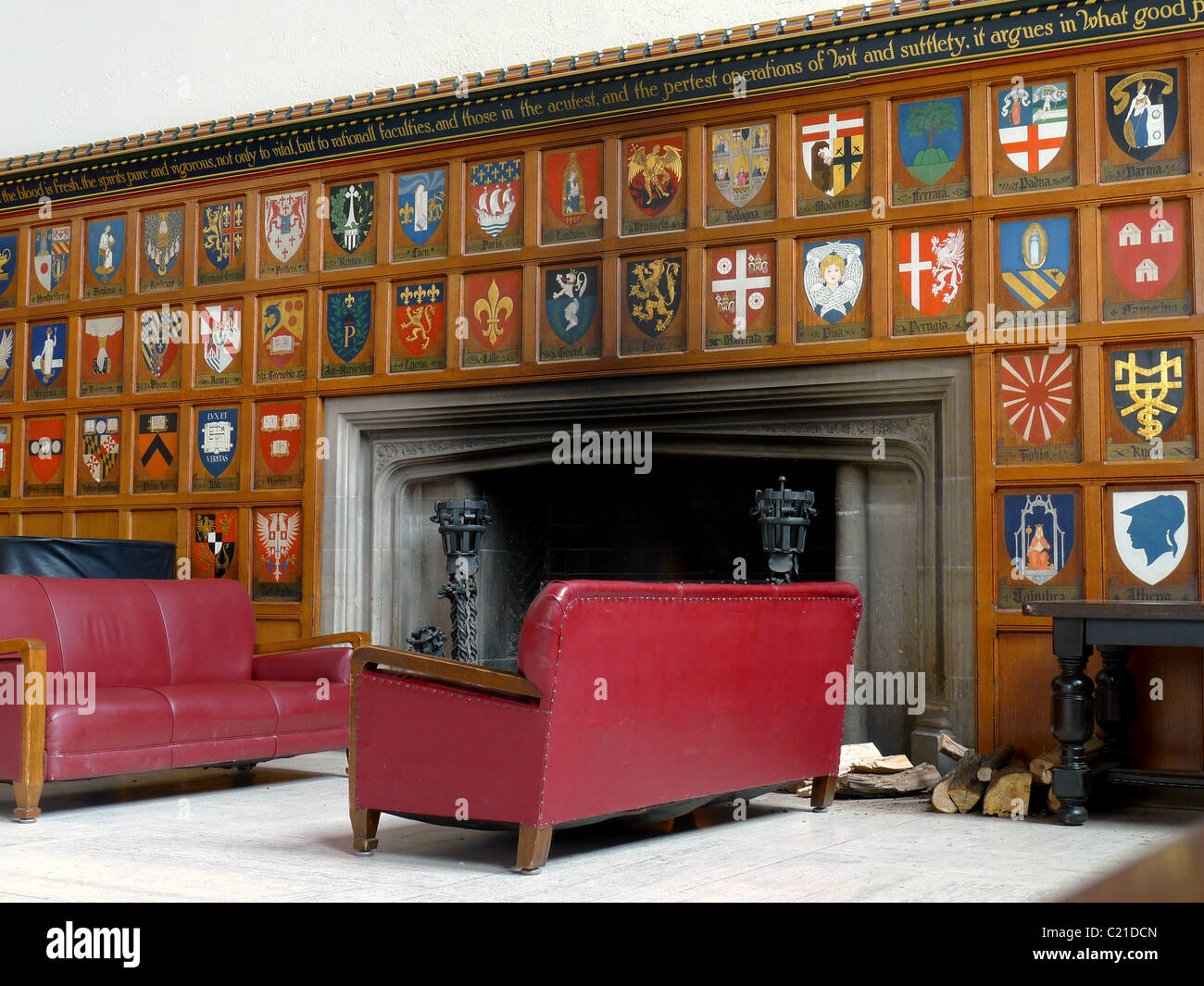 Fireplace and sofas in college common room Stock Photo