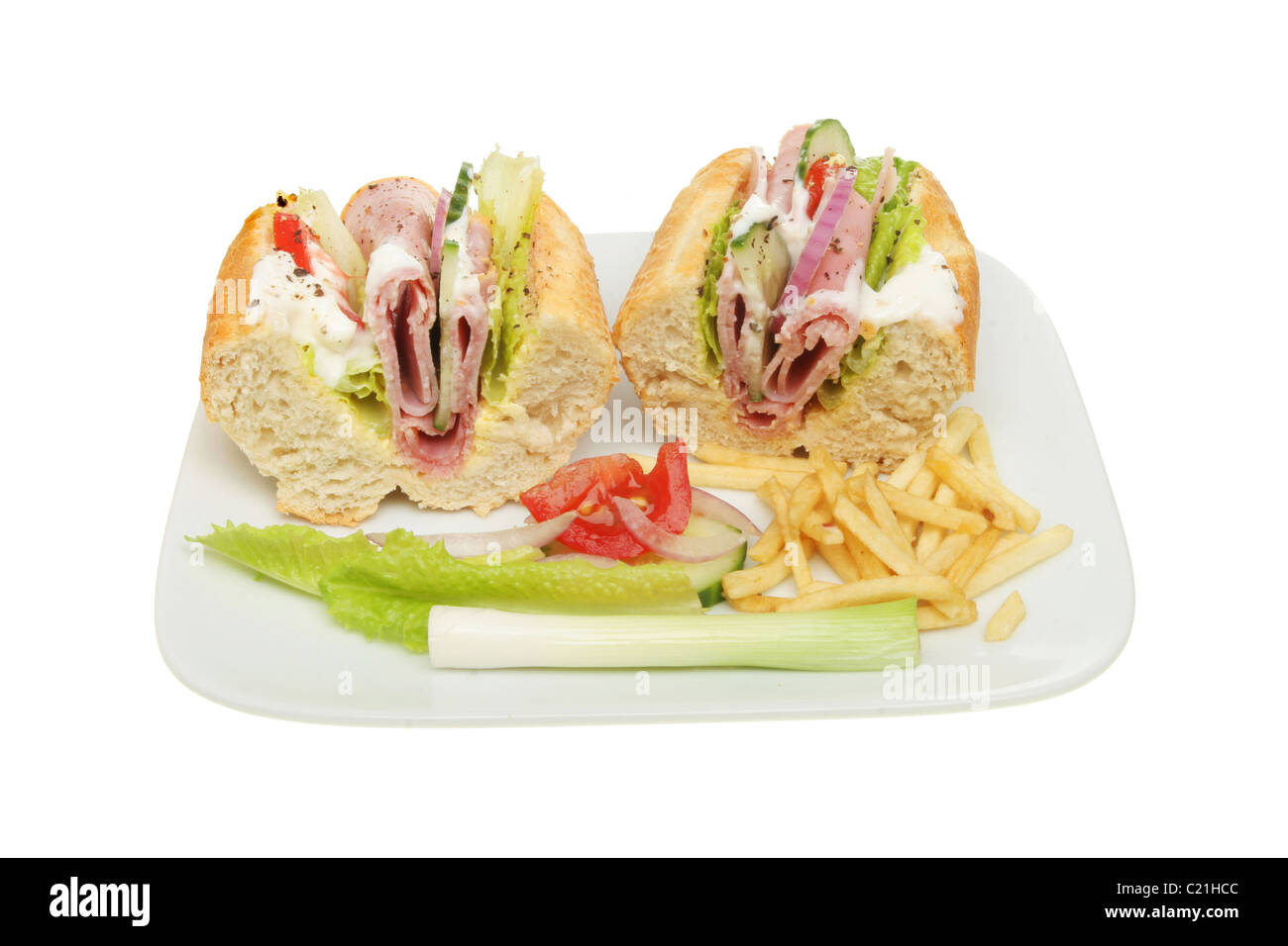 Ham salad baguette on a plate with a garnish of salad and potato chips Stock Photo