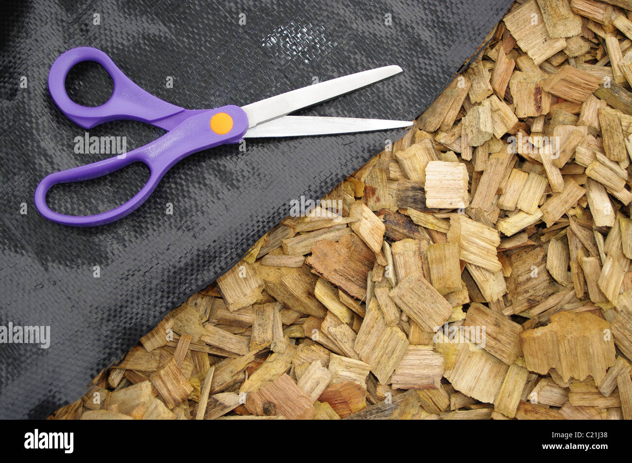 mulch weed Matt and scissors gardening Stock Photo